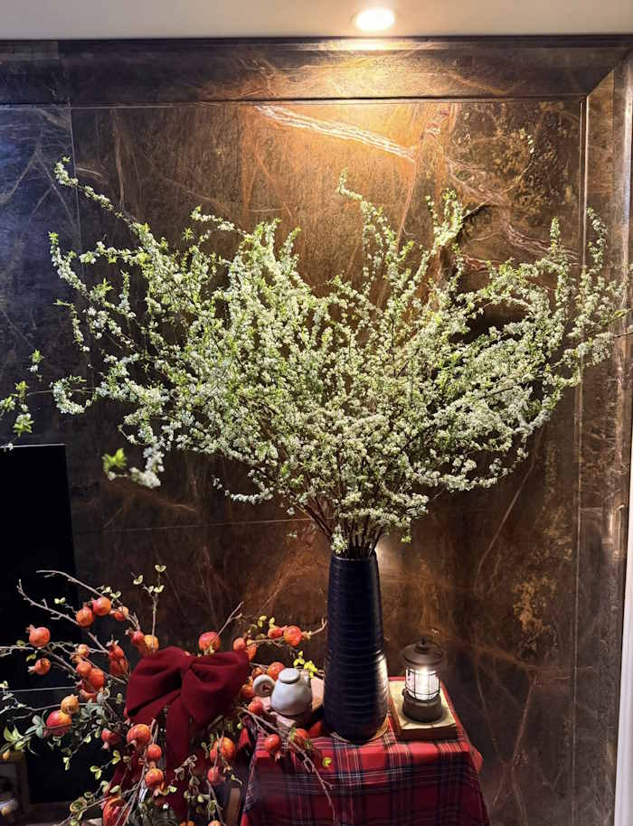 Cắm hoa tuyết mai trong bình gốm dài, tối màu